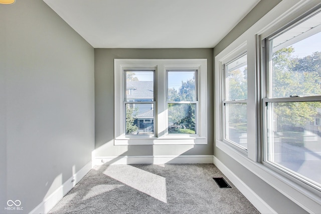 sunroom featuring a wealth of natural light and visible vents