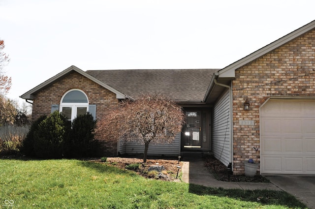 view of front of house with brick siding, roof with shingles, a front lawn, and an attached garage