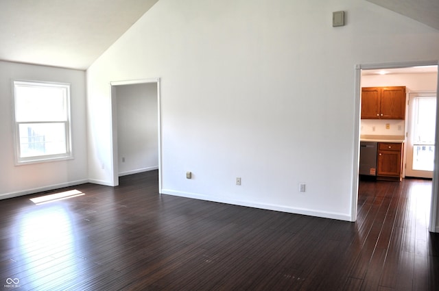 unfurnished living room featuring baseboards, vaulted ceiling, and dark wood finished floors