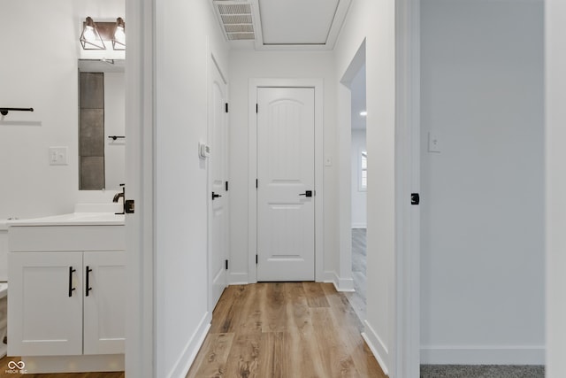 3105 N Tacoma Ave, Indianapolis, IN 46218 - hall with light wood finished floors, baseboards, and a sink
