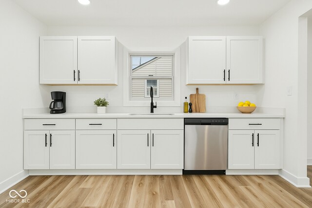 3105 N Tacoma Ave, Indianapolis, IN 46218 - kitchen featuring stainless steel dishwasher, a sink, recessed lighting, baseboards, and light wood-style floors