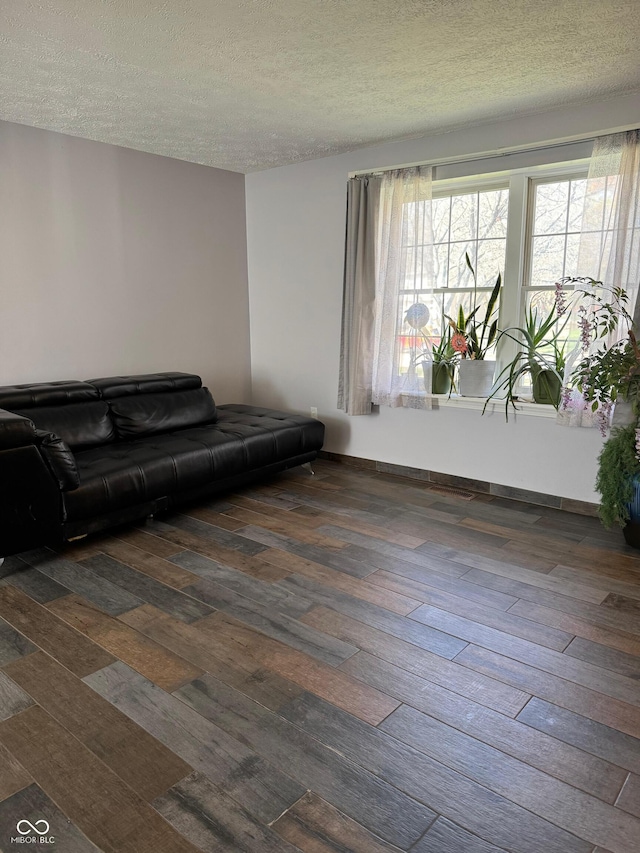 living room with hardwood / wood-style flooring and a textured ceiling