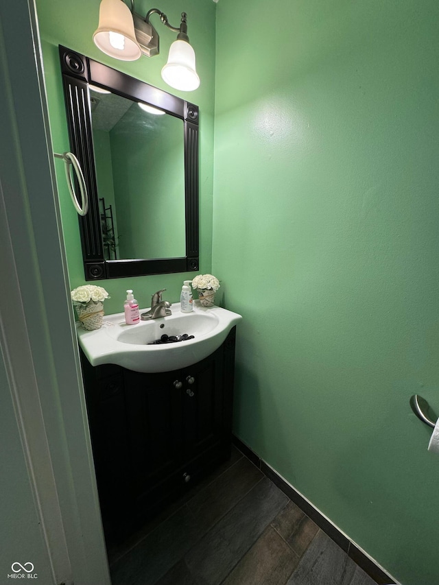 bathroom with vanity and wood finished floors