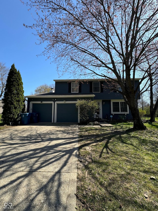 view of front of home featuring a front yard, a garage, and driveway