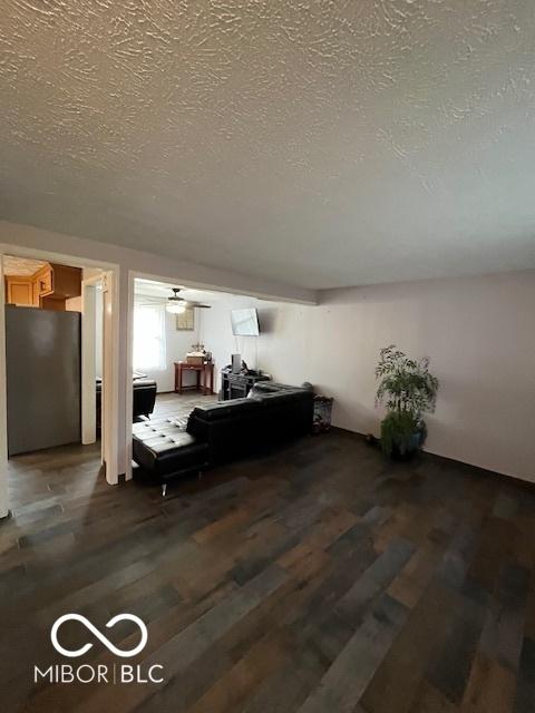 living room featuring a textured ceiling and wood finished floors