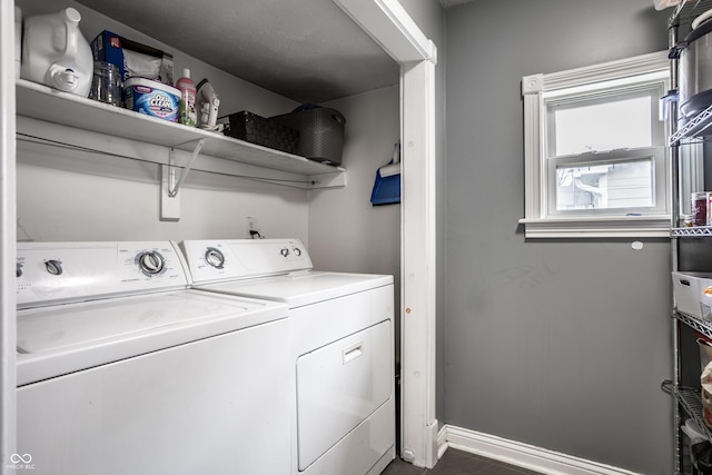 laundry area with washer and clothes dryer, laundry area, and baseboards