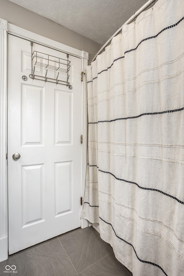 full bath with a textured ceiling