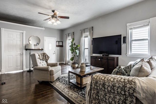 living room with baseboards, dark wood-style flooring, and ceiling fan