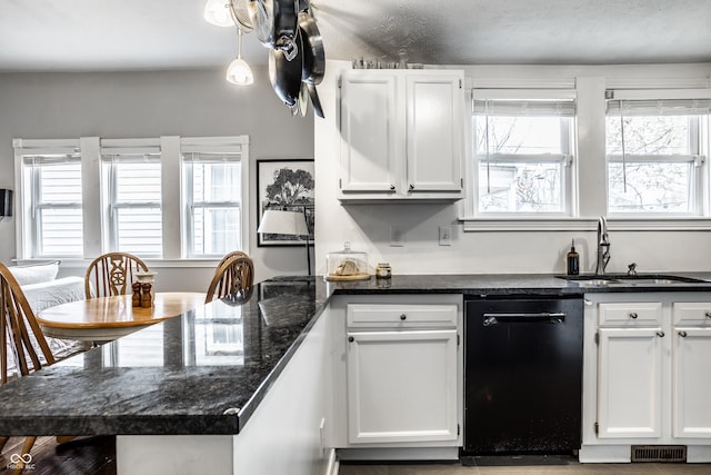 kitchen featuring white cabinetry, a sink, visible vents, dishwasher, and a peninsula