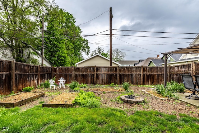 902 Villa Ave, Indianapolis, IN 46203 - fenced backyard with a garden and an outdoor fire pit
