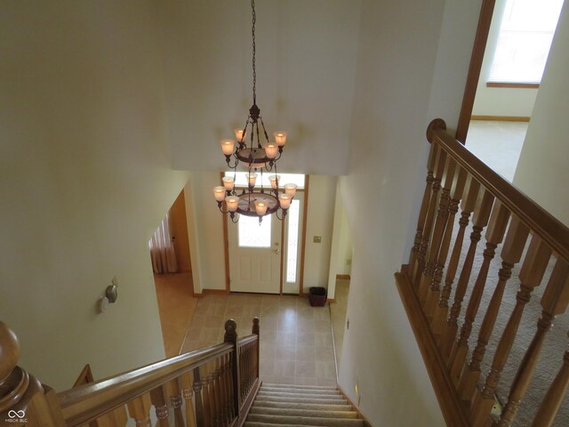 8358 Balmoral Dr, Avon, IN 46123 - stairway featuring a chandelier and tile patterned floors