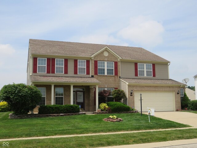 8358 Balmoral Dr, Avon, IN 46123 - view of front of home featuring an attached garage, driveway, brick siding, and a front lawn