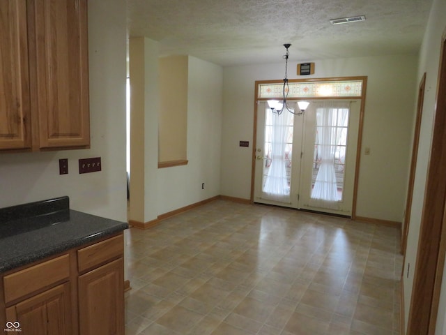8358 Balmoral Dr, Avon, IN 46123 - unfurnished dining area with a chandelier and a textured ceiling