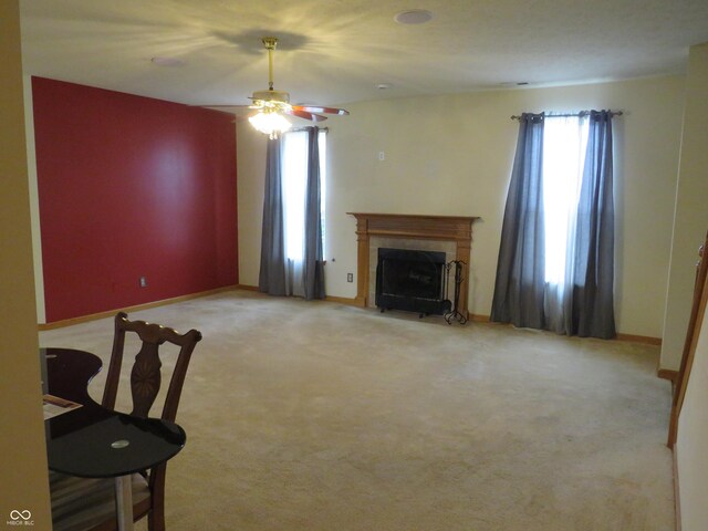 8358 Balmoral Dr, Avon, IN 46123 - unfurnished living room featuring a fireplace, ceiling fan, and light colored carpet