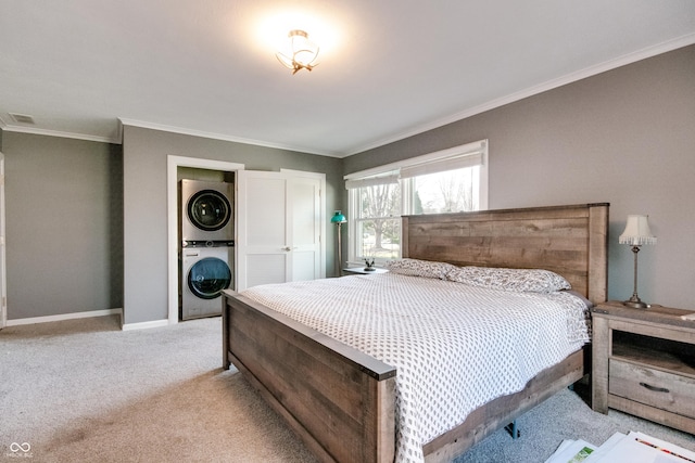 7525 N Meridian St, Indianapolis, IN 46260 - bedroom with visible vents, stacked washer / dryer, baseboards, ornamental molding, and light carpet