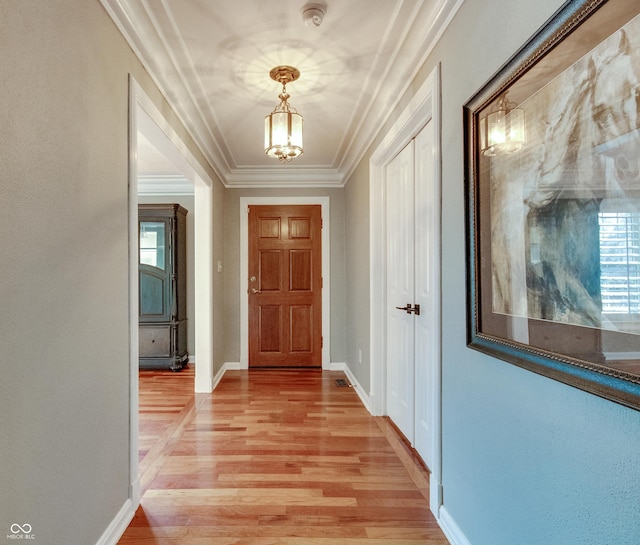 7525 N Meridian St, Indianapolis, IN 46260 - interior space featuring crown molding, light wood finished floors, baseboards, a healthy amount of sunlight, and an inviting chandelier