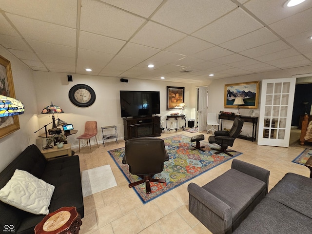 living room with baseboards, a paneled ceiling, recessed lighting, french doors, and tile patterned floors