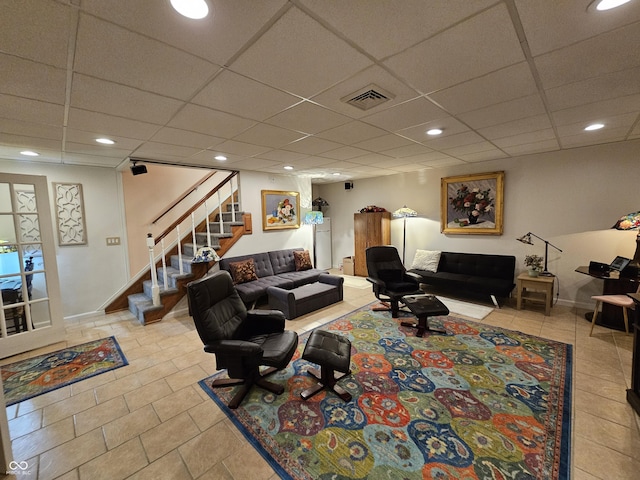 living room with recessed lighting, a drop ceiling, visible vents, and stairway