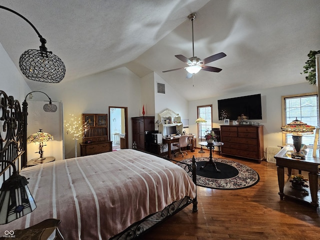 bedroom featuring a textured ceiling, wood finished floors, lofted ceiling, and visible vents