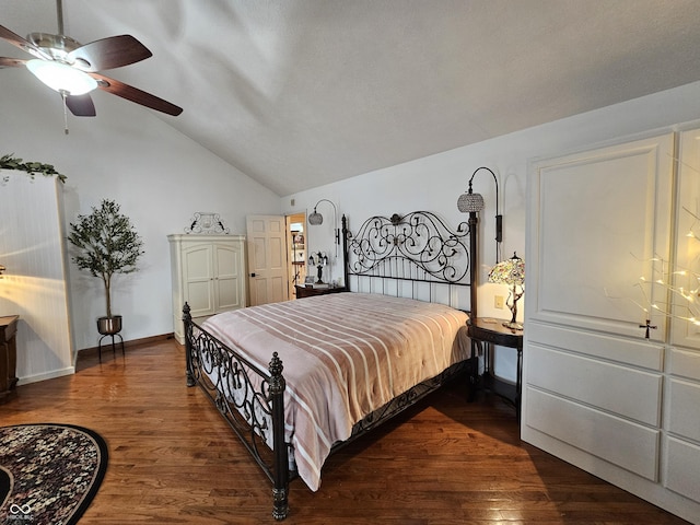 bedroom featuring dark wood-type flooring, ceiling fan, baseboards, and lofted ceiling