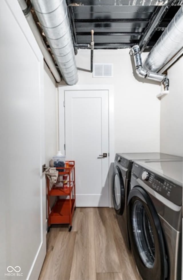 1802 Bellefontaine St, Indianapolis, IN 46202 - laundry area featuring light wood-style floors and washer and clothes dryer