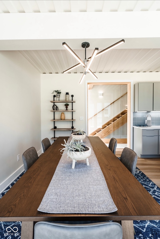 1802 Bellefontaine St, Indianapolis, IN 46202 - dining room with a chandelier, light wood-style flooring, and baseboards