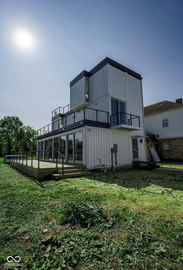1802 Bellefontaine St, Indianapolis, IN 46202 - back of property featuring a balcony, board and batten siding, and a yard