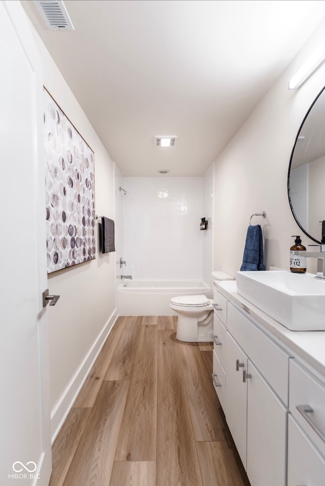1802 Bellefontaine St, Indianapolis, IN 46202 - bathroom with vanity, bathtub / shower combination, wood finished floors, and toilet