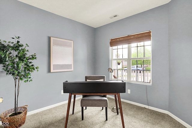 carpeted office space with baseboards and visible vents