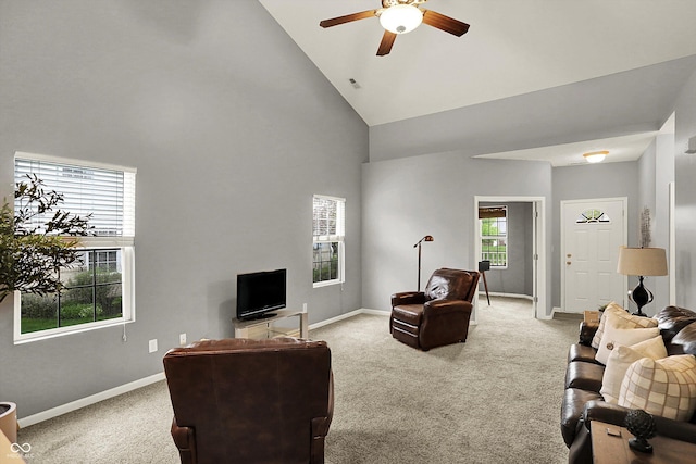 living room with light colored carpet, baseboards, ceiling fan, and high vaulted ceiling