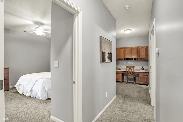 corridor featuring carpet floors and baseboards
