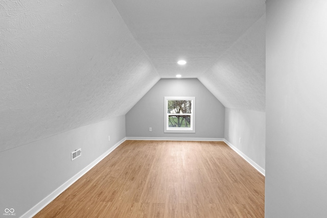 555 N Hamilton Ave, Indianapolis, IN 46201 - bonus room featuring vaulted ceiling, baseboards, a textured ceiling, visible vents, and light wood-style flooring