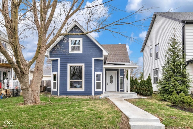 555 N Hamilton Ave, Indianapolis, IN 46201 - view of front facade featuring a shingled roof, a front yard, and fence