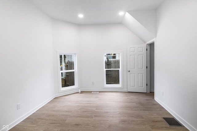 555 N Hamilton Ave, Indianapolis, IN 46201 - unfurnished room featuring recessed lighting, high vaulted ceiling, baseboards, visible vents, and wood finished floors