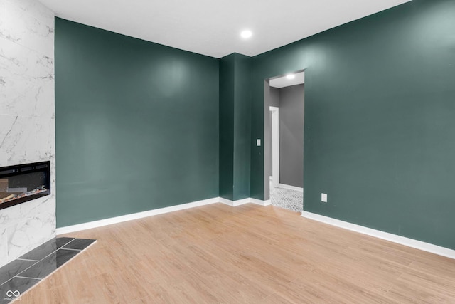 555 N Hamilton Ave, Indianapolis, IN 46201 - unfurnished living room featuring baseboards, wood finished floors, and a premium fireplace