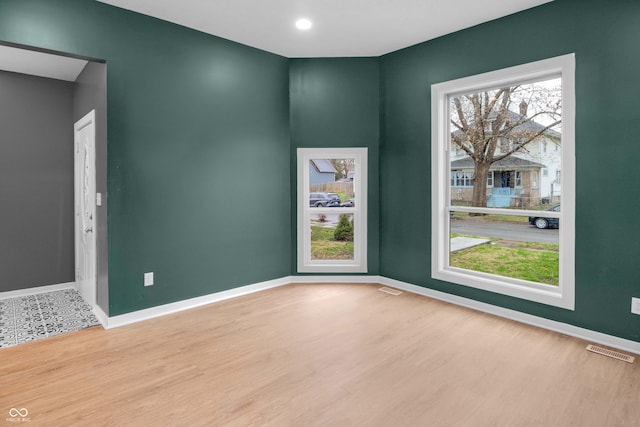 555 N Hamilton Ave, Indianapolis, IN 46201 - empty room with baseboards, visible vents, and wood finished floors