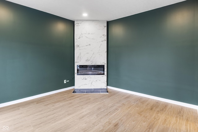 555 N Hamilton Ave, Indianapolis, IN 46201 - unfurnished room with baseboards, a fireplace, and wood finished floors