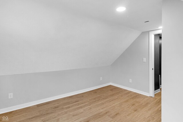 555 N Hamilton Ave, Indianapolis, IN 46201 - additional living space featuring baseboards, lofted ceiling, recessed lighting, and light wood-type flooring