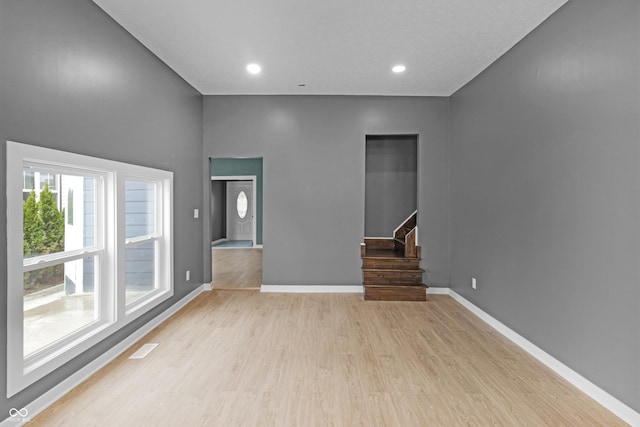 555 N Hamilton Ave, Indianapolis, IN 46201 - unfurnished living room featuring visible vents, light wood finished floors, baseboards, recessed lighting, and stairway