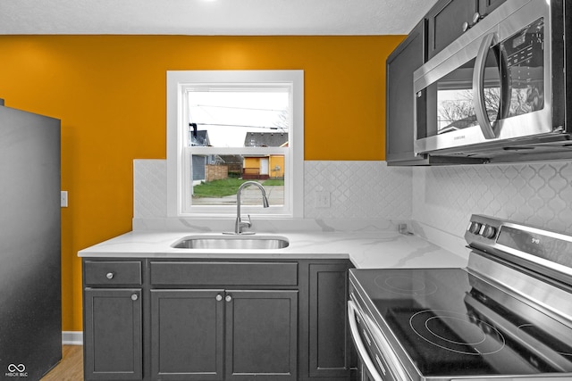 555 N Hamilton Ave, Indianapolis, IN 46201 - kitchen with a sink, tasteful backsplash, appliances with stainless steel finishes, and light stone counters
