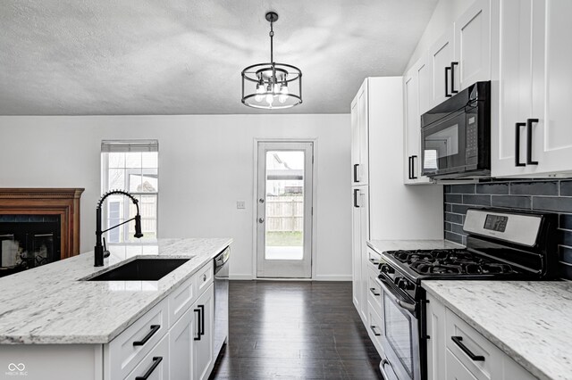 6036 Terrytown Pkwy, Indianapolis, IN 46254 - kitchen featuring a sink, a chandelier, stainless steel appliances, plenty of natural light, and decorative backsplash
