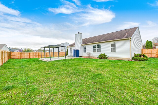 6036 Terrytown Pkwy, Indianapolis, IN 46254 - back of house featuring a lawn, a chimney, a fenced backyard, and a patio area