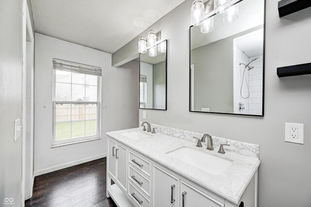 6036 Terrytown Pkwy, Indianapolis, IN 46254 - full bathroom featuring baseboards, double vanity, a sink, and wood finished floors