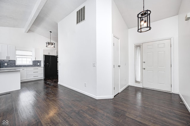 6036 Terrytown Pkwy, Indianapolis, IN 46254 - entryway featuring baseboards, dark wood-style floors, visible vents, and vaulted ceiling with beams