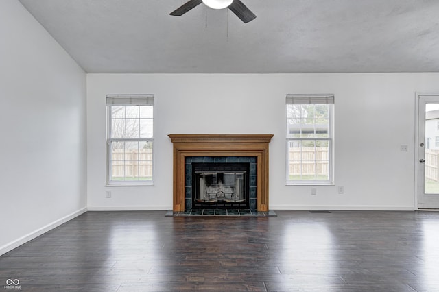 6036 Terrytown Pkwy, Indianapolis, IN 46254 - unfurnished living room featuring visible vents, baseboards, a fireplace, a ceiling fan, and dark wood-type flooring