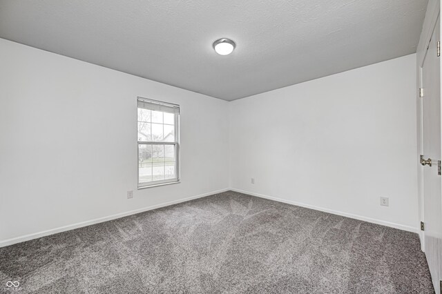 6036 Terrytown Pkwy, Indianapolis, IN 46254 - unfurnished room featuring baseboards, a textured ceiling, and carpet