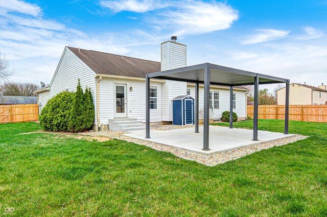 6036 Terrytown Pkwy, Indianapolis, IN 46254 - back of house with fence, entry steps, a chimney, a lawn, and a patio area