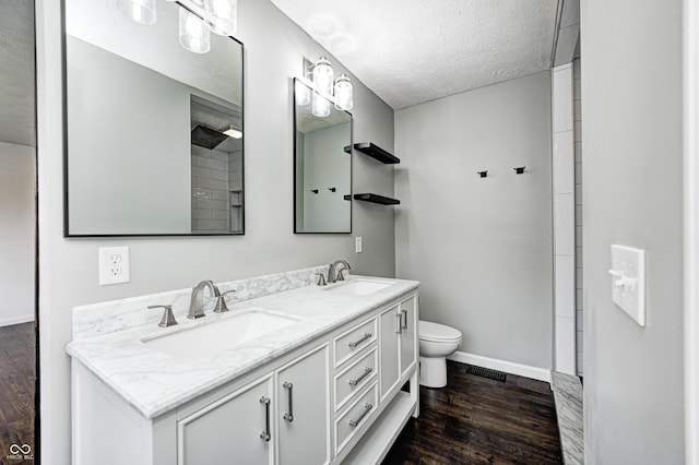6036 Terrytown Pkwy, Indianapolis, IN 46254 - bathroom featuring baseboards, a textured ceiling, a sink, and wood finished floors