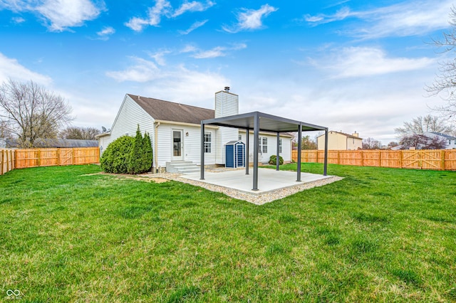 6036 Terrytown Pkwy, Indianapolis, IN 46254 - rear view of house with an outdoor structure, a fenced backyard, a yard, and a chimney