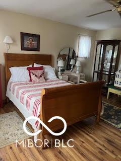 bedroom featuring wood finished floors and ceiling fan